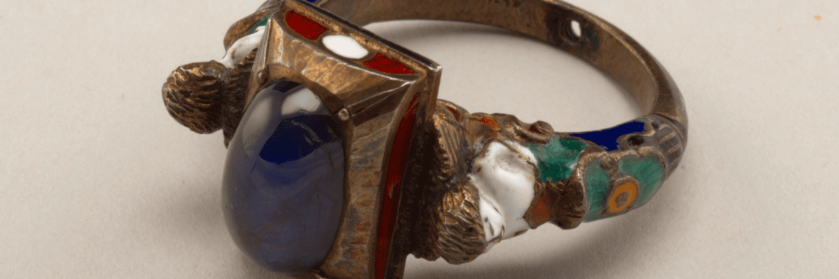 Timeless jewelry antique gold ring with cabochon sapphire, cloisonne enamel, and pearl accents.