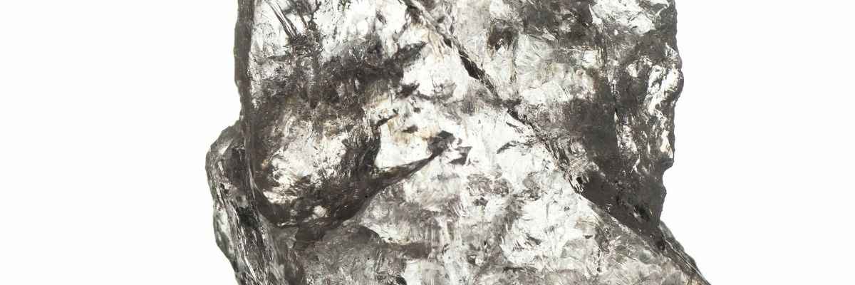 Raw rock crystal block with natural inclusions and glass-like clarity, origin of carved rock crystal glasses