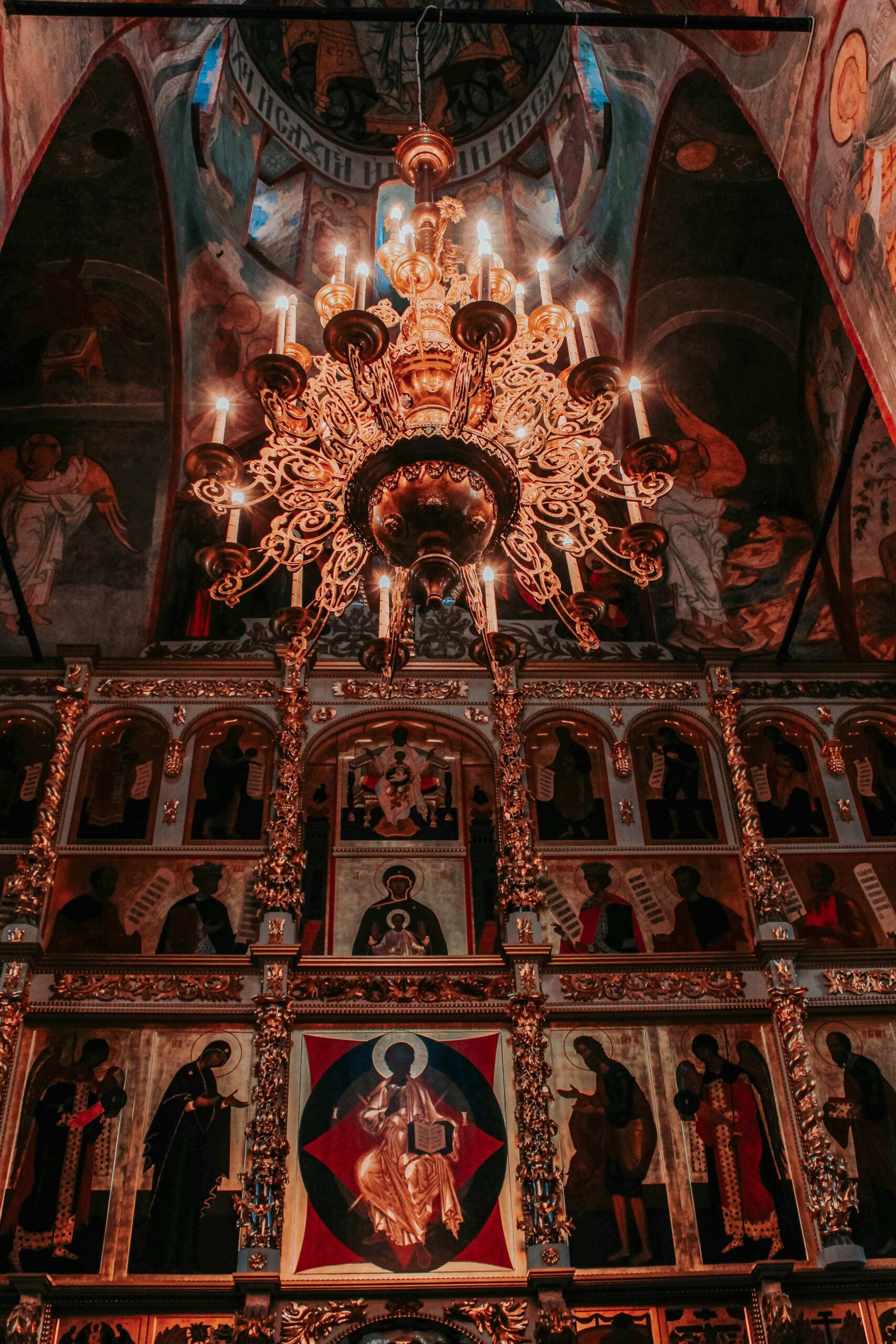 Gilded Orthodox iconostasis with chandelier and frescoed dome — the splendour of the Easter vigil tradition